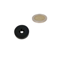 Black ring magnet 25.4 mm diameter with plastic protective layer and countersunk hole next to silver coin for bowl and magnetic force