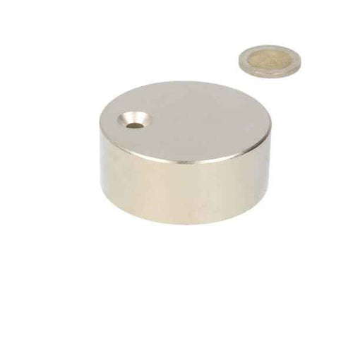 A neodymium magnet disc of 60 x 25 mm with countersunk hole and a polished metal finish for various applications