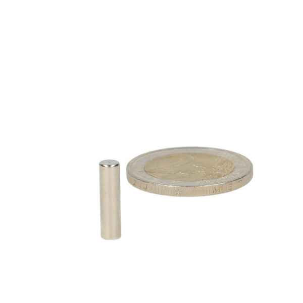 Silver cylindrical high-grade neodymium magnet 4 x 15 mm next to euro coin for scale comparison